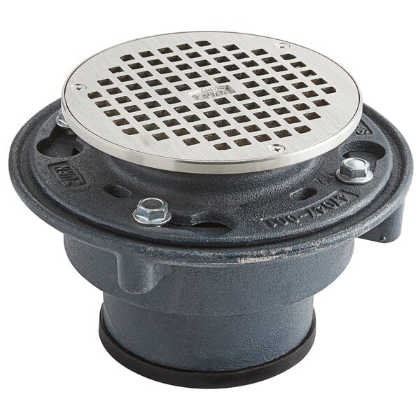 A Zurn round metal floor drain with a round metal cover with holes.