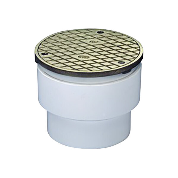 A white plastic Zurn floor drain with a round metal cover.