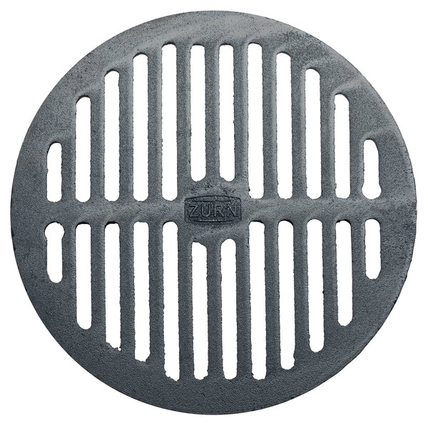 A Zurn round metal grate with holes.