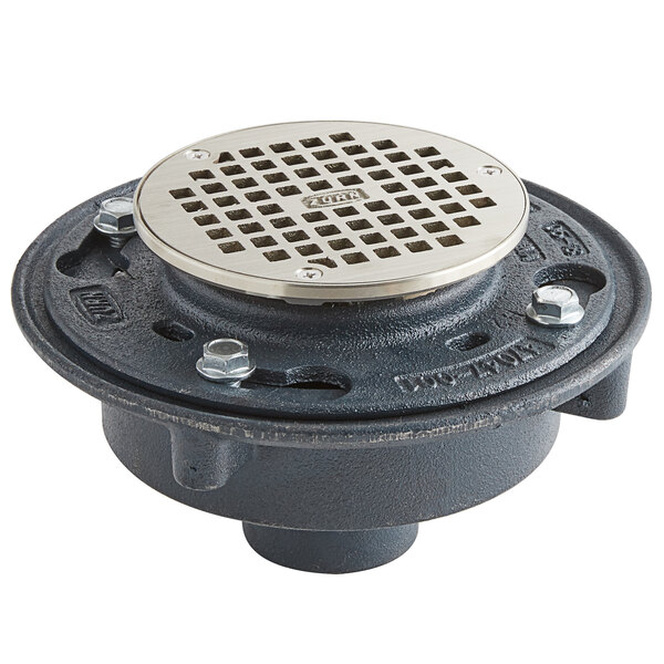A black metal Zurn floor drain with a silver metal strainer cover.