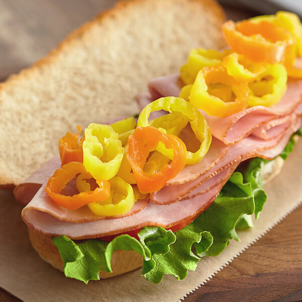 A sandwich with Del Sol banana pepper rings on a counter.