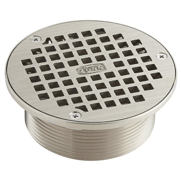 A Zurn polished nickel bronze drain cover with square openings.