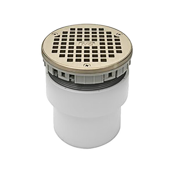 A white plastic Zurn round floor drain with a silver metal lid.