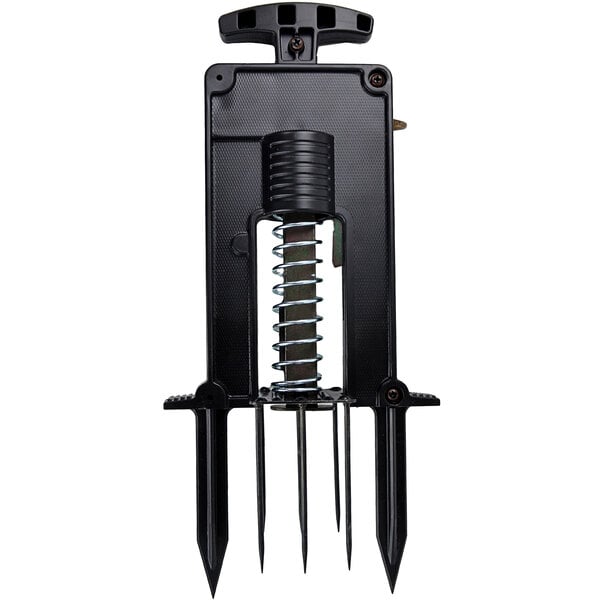 A black plastic Victor mole trap with a metal spring and two spikes.