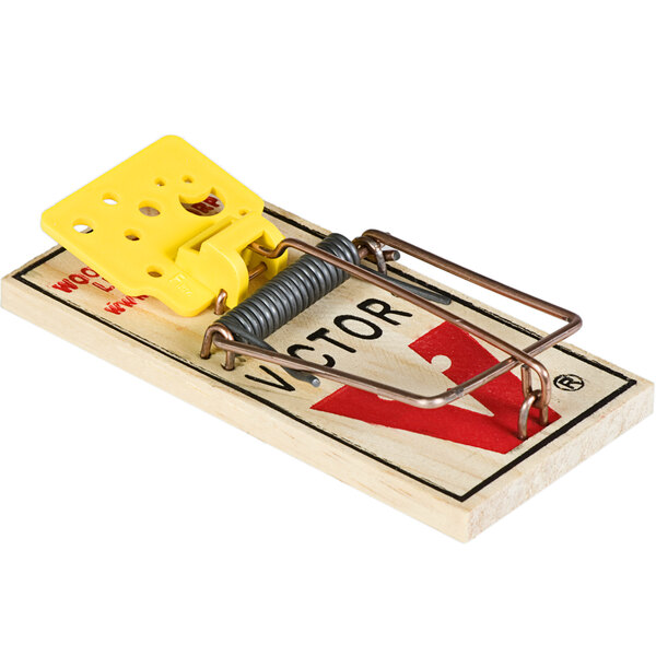 A Victor Pest wood mouse trap with a yellow plastic piece on it.