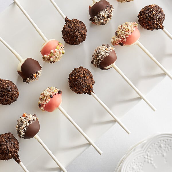 Les Chateaux de France chocolate cheesecake pops on a white plate.