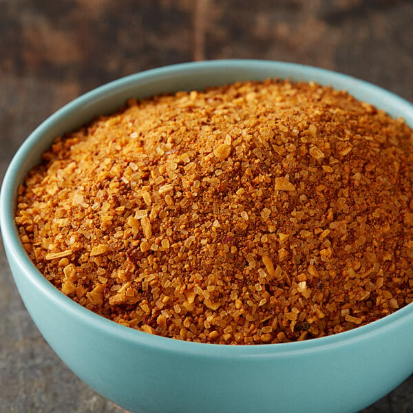 A bowl of McCormick Grill Mates Smokehouse Maple seasoning on a table.