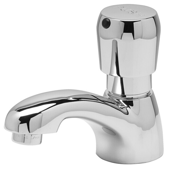 A Zurn metering faucet with a chrome finish and handle.