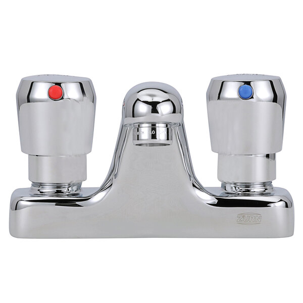 A Zurn deck mount metering faucet with two red and blue knobs.
