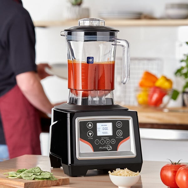 An AvaMix commercial blender with red liquid in it.