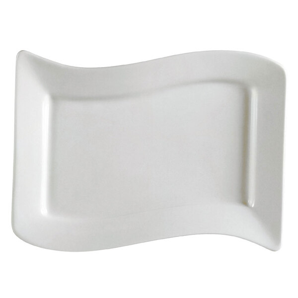 A CAC rectangular ivory stoneware platter with a curved edge.