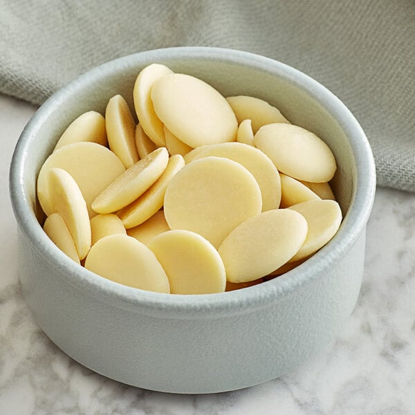 A bowl of Guittard white chocolate wafers.