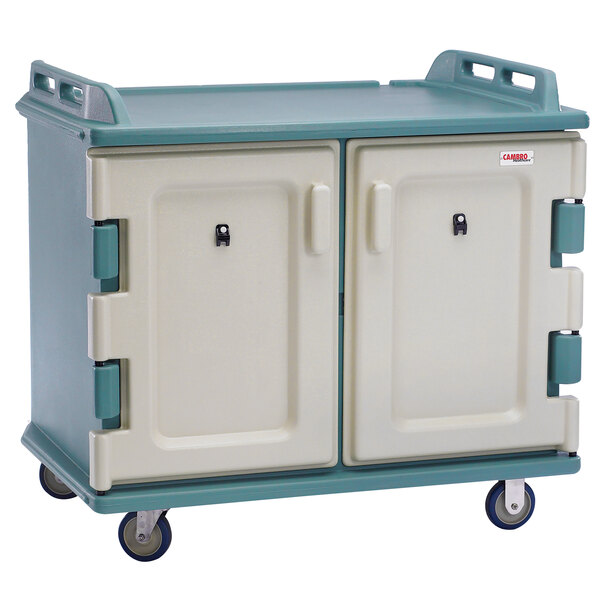 A white and green Cambro meal delivery cart with wheels and two doors.