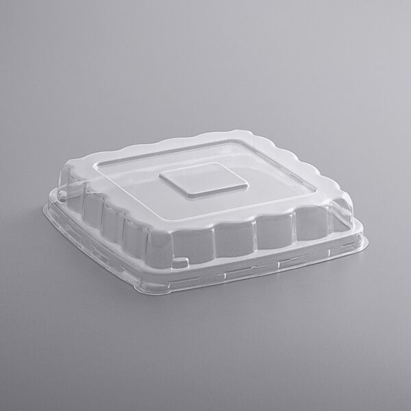 A white plastic container with a clear square dome lid.