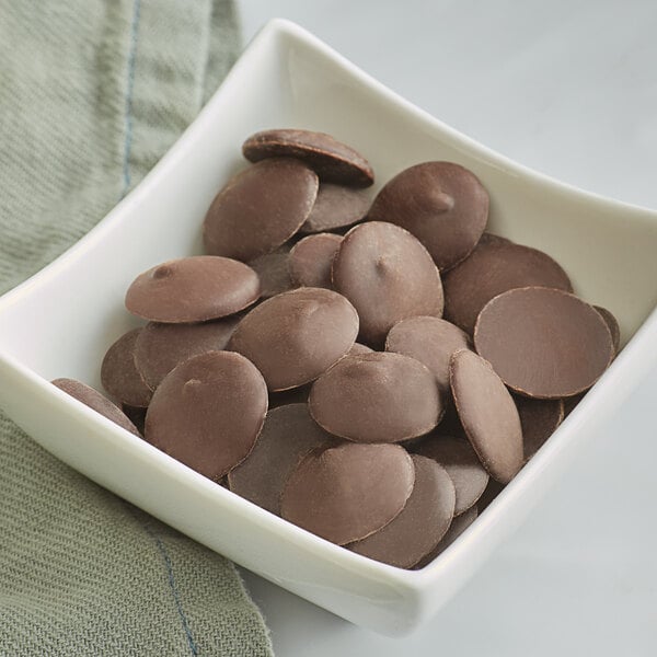 A bowl of Guittard L'Etoile du Nord semi-sweet chocolate wafers.