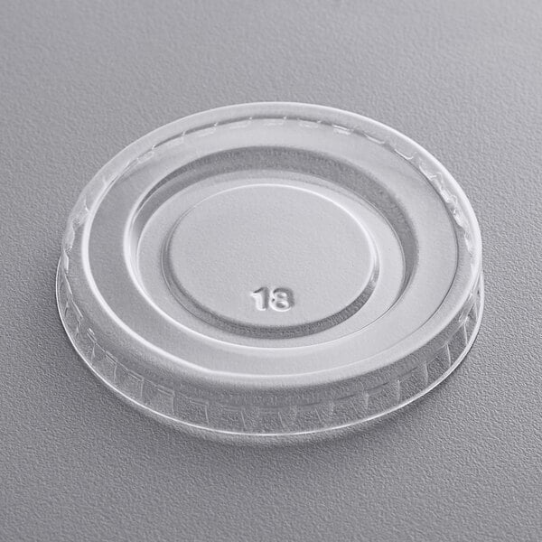 A Fineline clear plastic lid with a number on it.