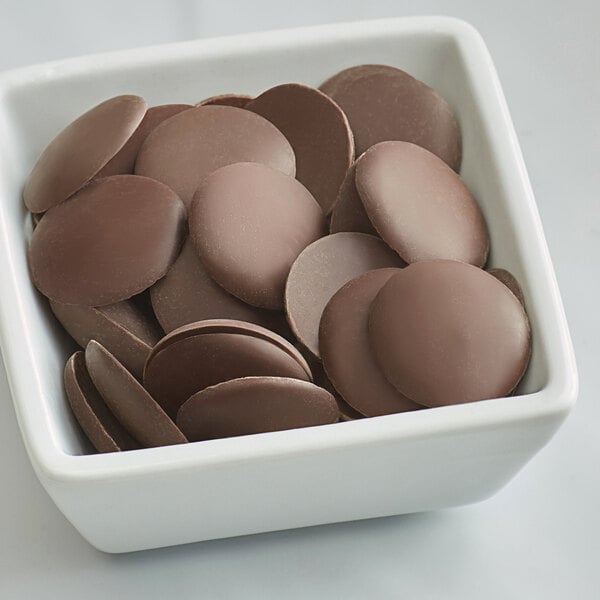 A bowl of Guittard La Nuit Noire semi-sweet chocolate wafers.