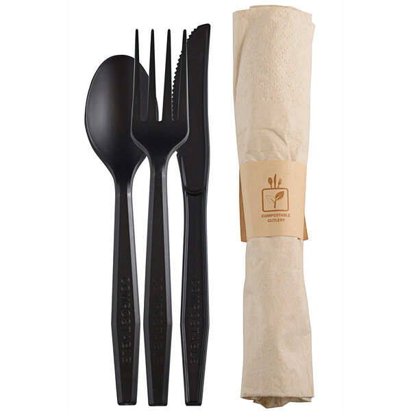 A black paper wrapper containing a black napkin, black fork, and black spoon.