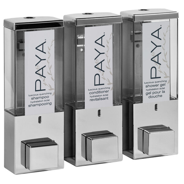 A chrome wall-mounted dispenser with three translucent bottles with the word "Paya" on them.