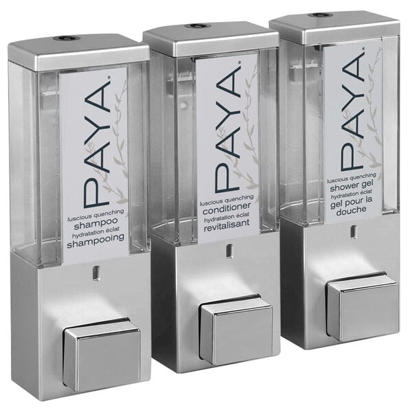 Three satin silver wall-mounted Dispenser Amenities with translucent bottles and a Paya logo.