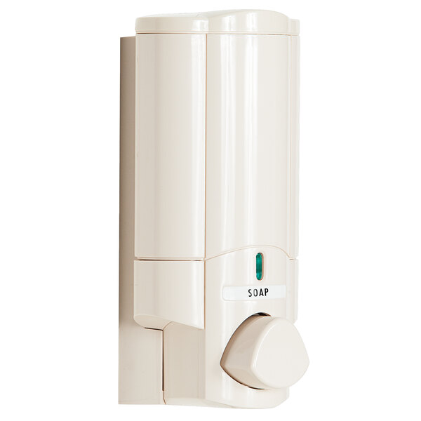 A white wall-mounted Aviva shower soap dispenser with a round white button and label.