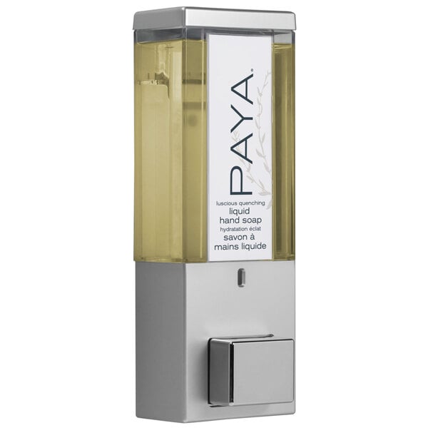 A satin silver wall-mounted Dispenser Amenities Paya shower dispenser with translucent bottle and Paya logo.
