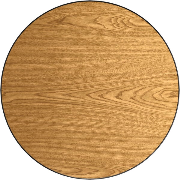 A Lancaster Table & Seating round laminated table top with walnut and oak wood grains.