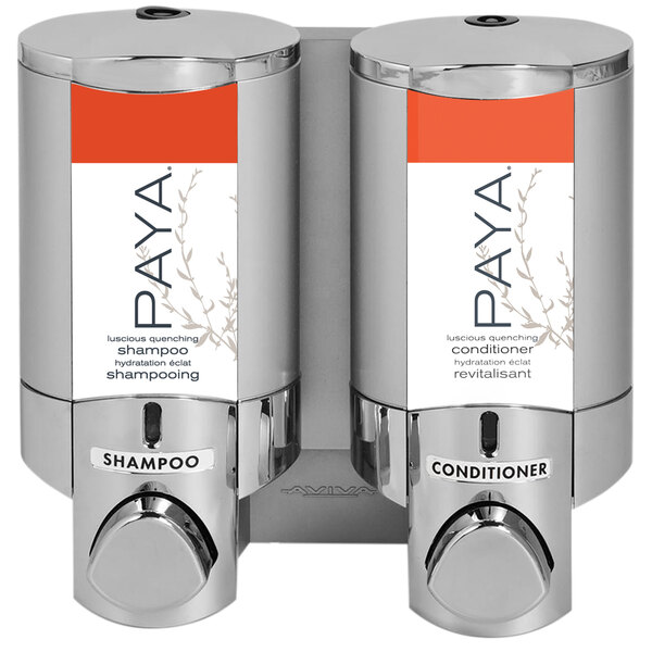 A chrome wall-mounted dispenser with two satin silver bottles with white labels and a Paya logo.