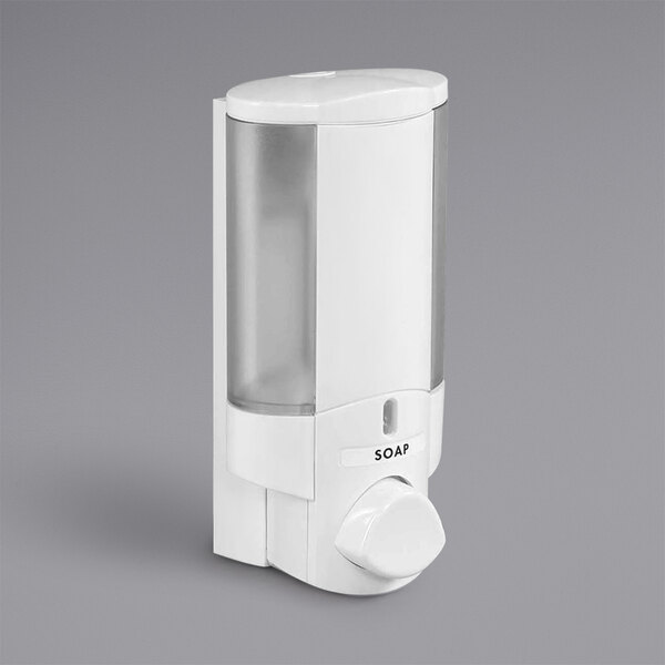 A white Dispenser Amenities Aviva soap dispenser with a clear plastic container.