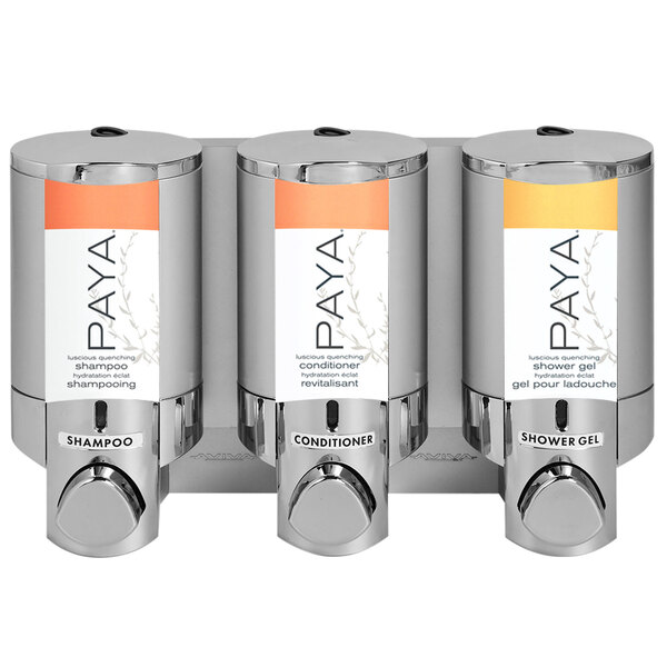 A chrome Dispenser Amenities wall mounted shower dispenser with three satin silver bottles and a Paya logo.