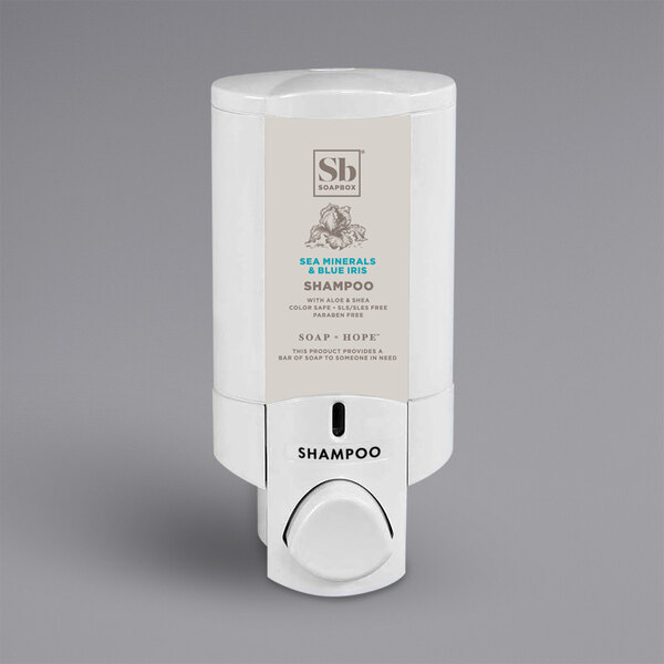 A white Aviva wall-mounted shower dispenser with a bottle of shampoo and a Soapbox label.