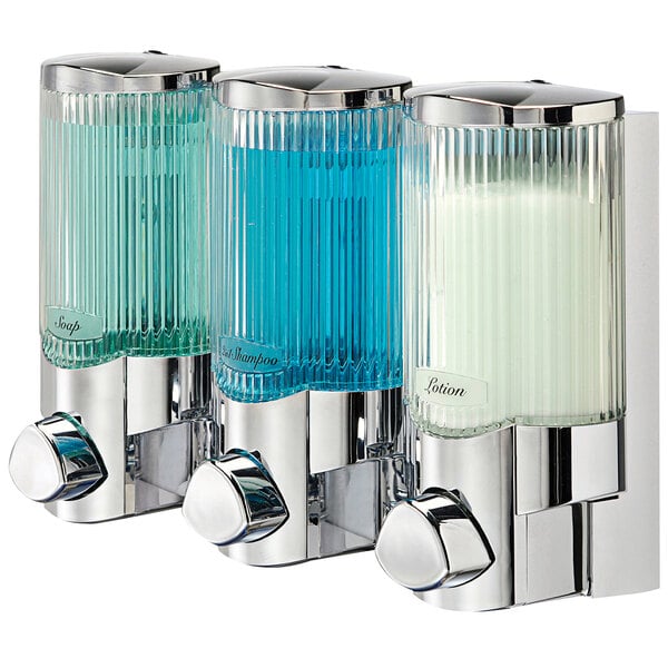 A chrome wall-mounted soap dispenser with three translucent bottles.