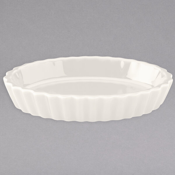 A white round dish with a wavy edge.