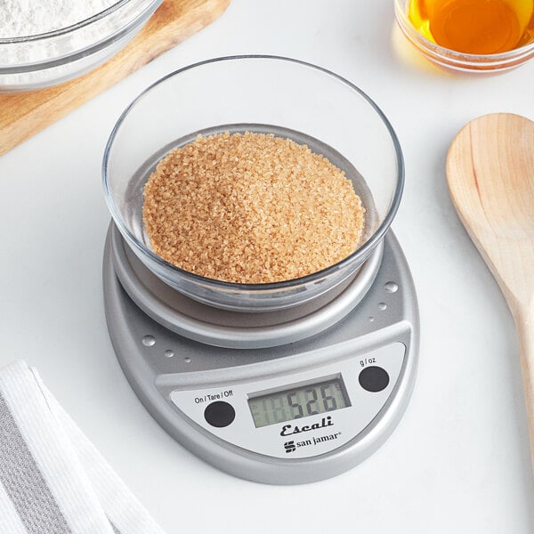A San Jamar digital portion scale with a bowl of brown sugar on it.