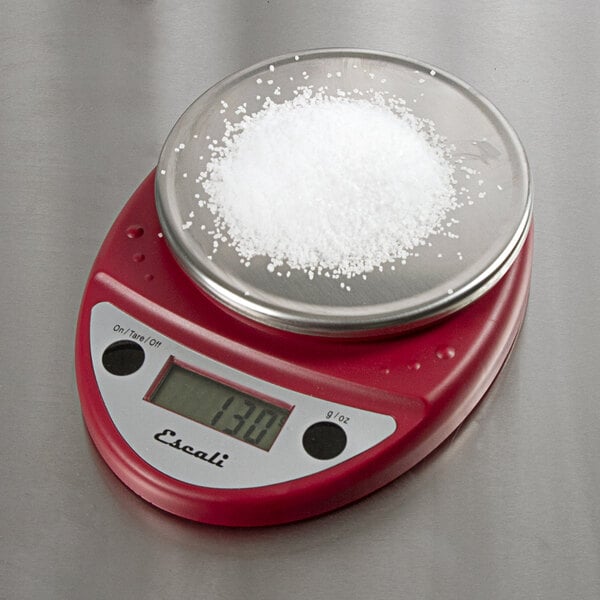 A red San Jamar digital portion scale with a bowl of salt on it.