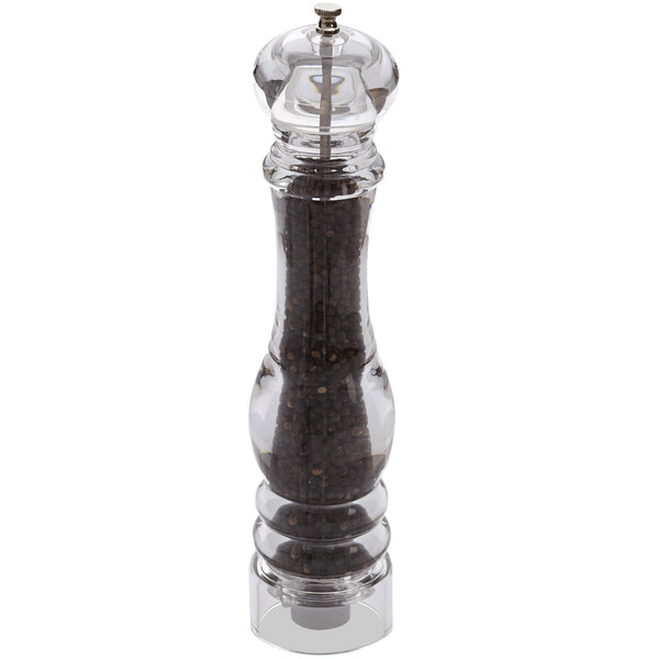 An American Metalcraft acrylic pepper mill filled with black pepper on a table.