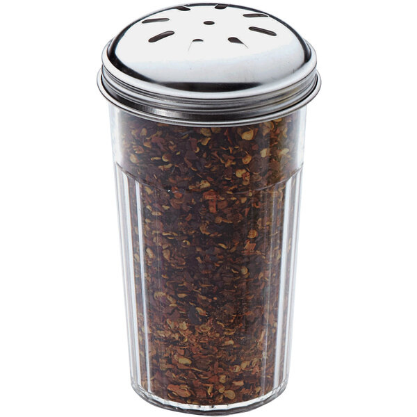 An American Metalcraft plastic spice shaker with a perforated metal top full of crushed red pepper on a counter.