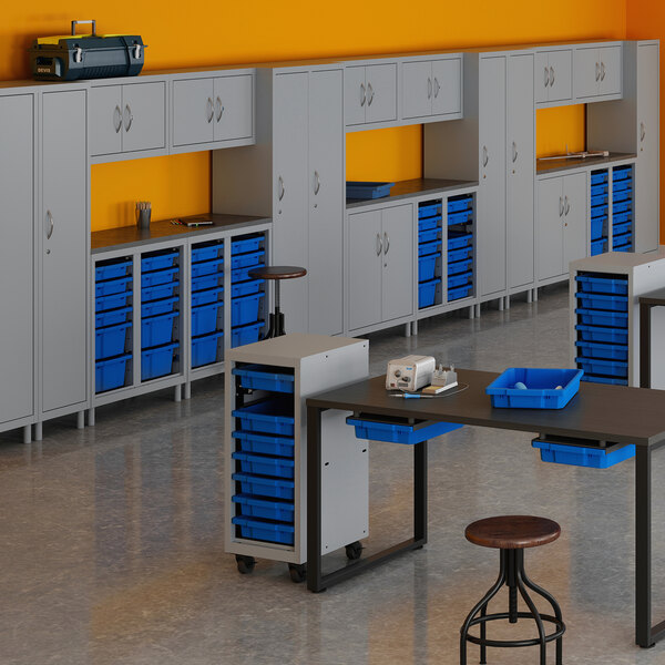 A shelf with a Hirsh Industries Huxley storage cabinet and blue bins.