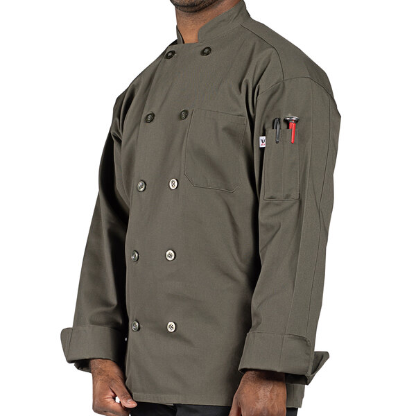 A man wearing a Uncommon Chef olive green long sleeve chef coat with black pants.