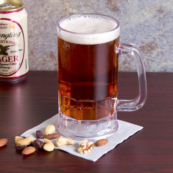 A customizable plastic beer mug filled with beer and nuts on a counter.