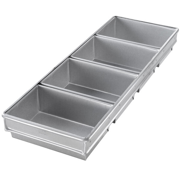 A rectangular metal bread loaf pan with four compartments.