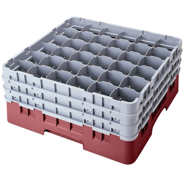 A red plastic Cambro glass rack with several compartments and gray extenders.