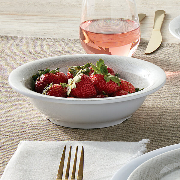 A Jane Casual American Metalcraft melamine bowl filled with strawberries on a table.