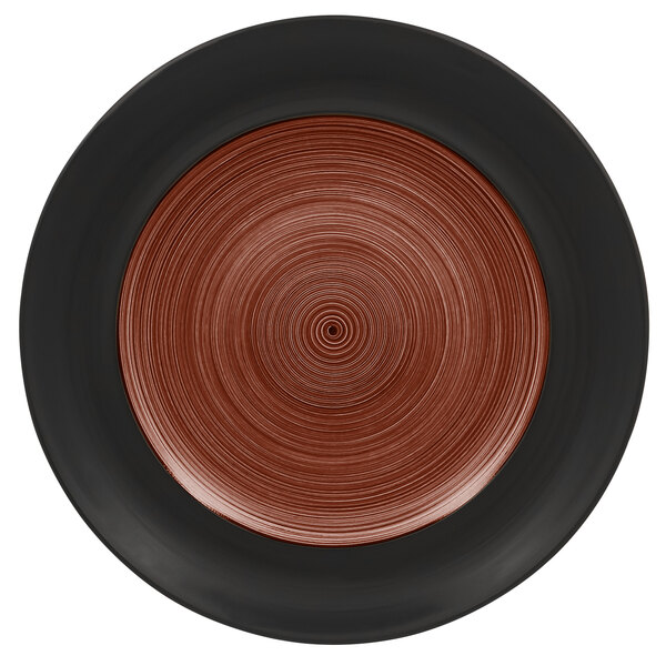 A white porcelain plate with a black and walnut circular pattern on the rim.