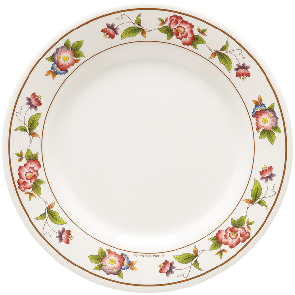 A white round melamine plate with tea roses on it.