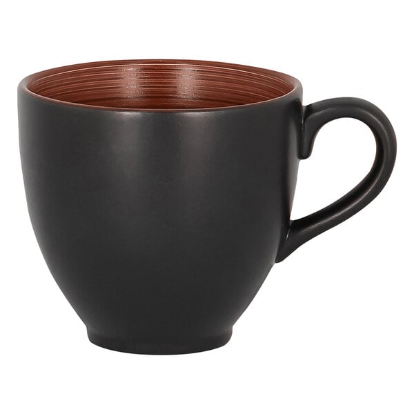 A white RAK Porcelain cup with a black exterior and brown rim and handle.