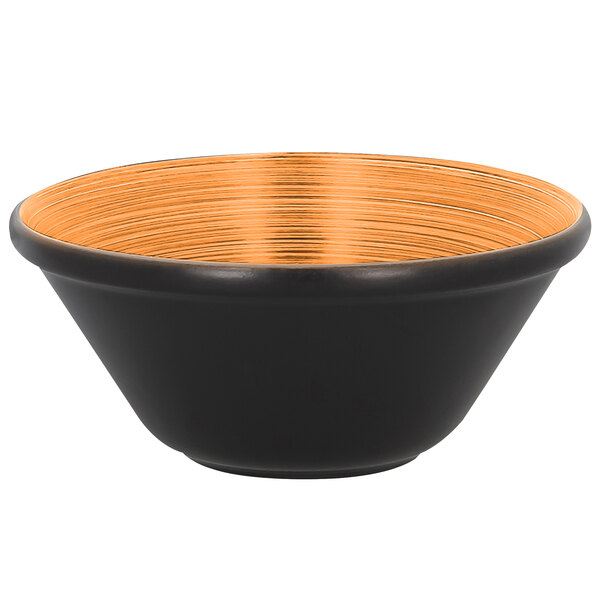 A black RAK Porcelain bowl with an orange rim on a counter.
