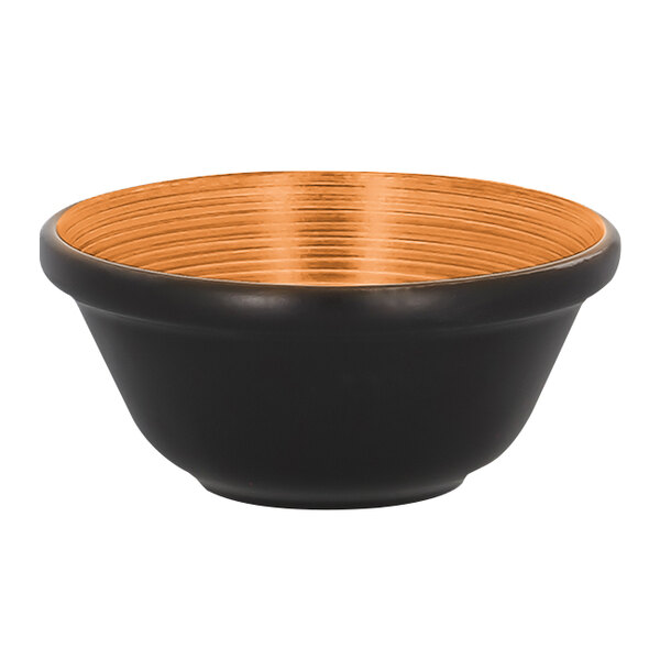 A black RAK Porcelain bowl with an orange rim.