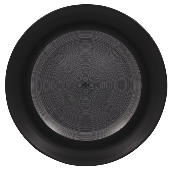 A black porcelain plate with a white spiral pattern on the rim.