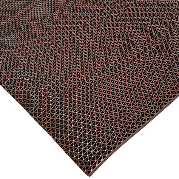 A brown Cactus Mat Safety-Walk wet area mat with holes in it.